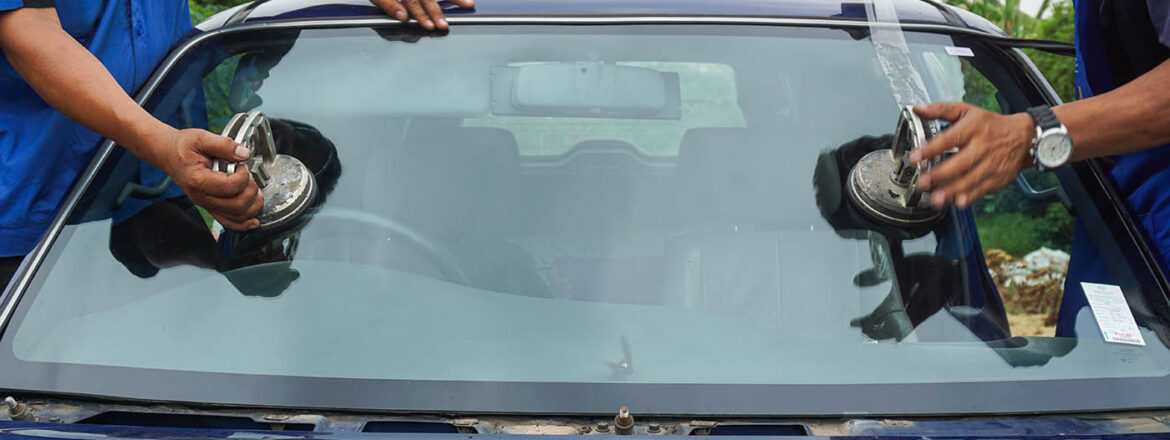 Glazier using tools repairing to fix crack broken windshield, wi